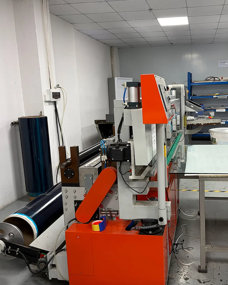 An industrial-scale carbon fiber cutting workshop featuring high-precision CNC machinery for the accurate shaping of professional pickleball paddle faces.