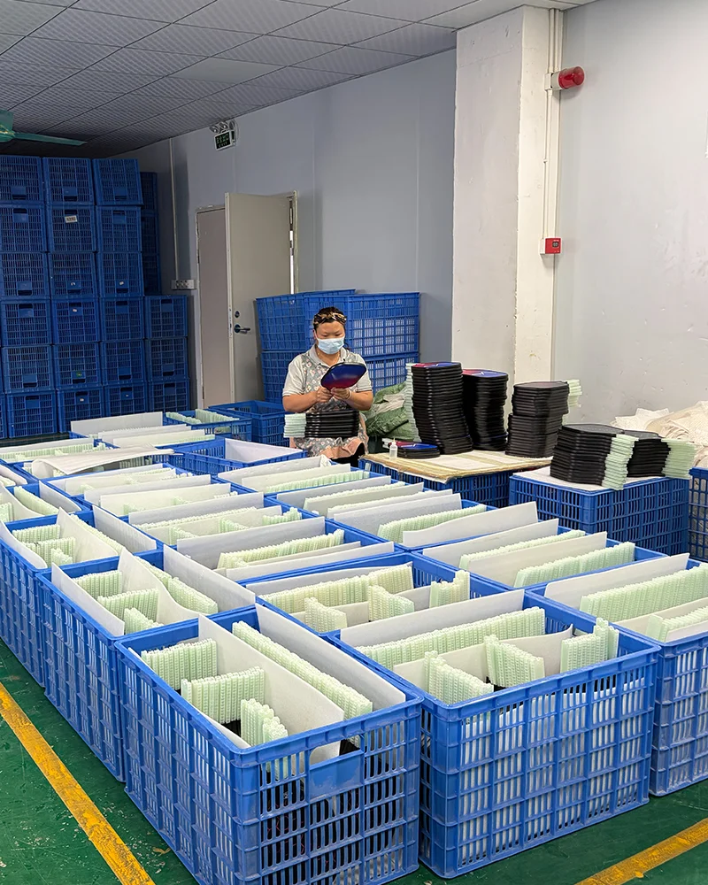 A quality control specialist inspecting a large batch of printed pickleball paddles to ensure color accuracy and surface integrity before final packaging.