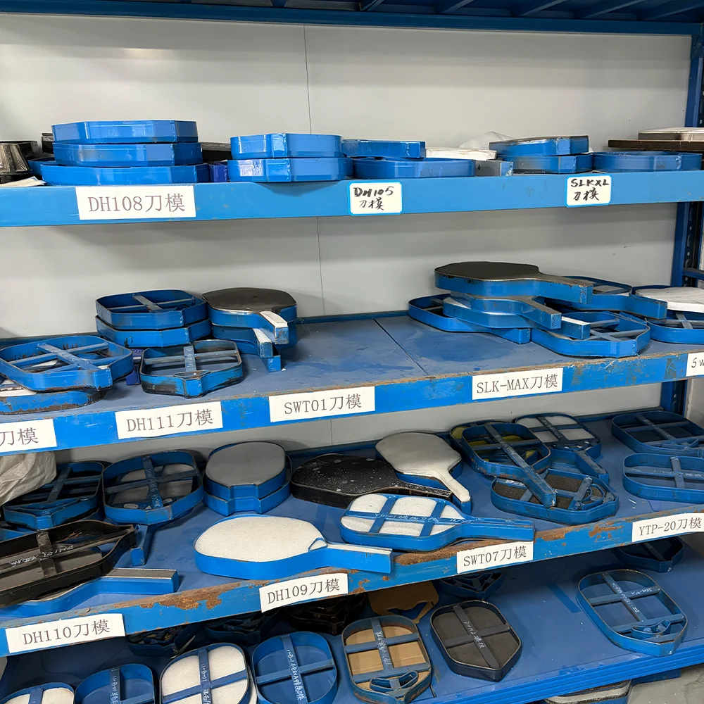 A wide collection of precision steel cutting dies used for shaping various pickleball paddle models, showcasing our extensive OEM customization capabilities.