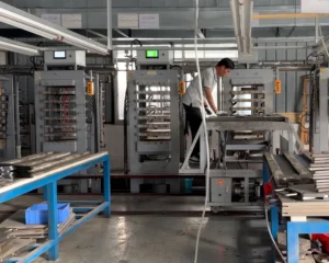professional-thermoforming-process-pickleball-factory A skilled technician operating a high-pressure thermoforming machine, ensuring precise temperature and pressure control for unibody pickleball paddle construction.